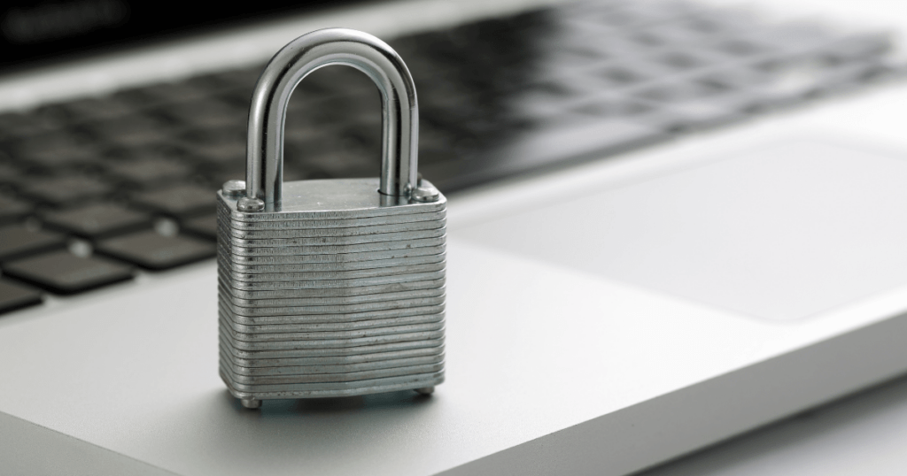 A lock sitting on a laptop to represent cyber security