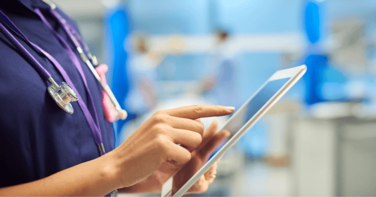 Healthcare worker using ipad to enter patient details